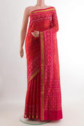 Red Rajkot Patola Silk Saree with Ikat design on the body and Zari Border.  displayed on a mannequin