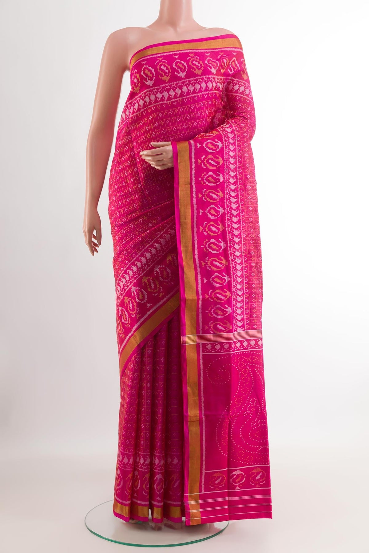 Pink Rajkot Patola Silk Saree with Ikat design on the body and Zari Border.  displayed on a mannequin