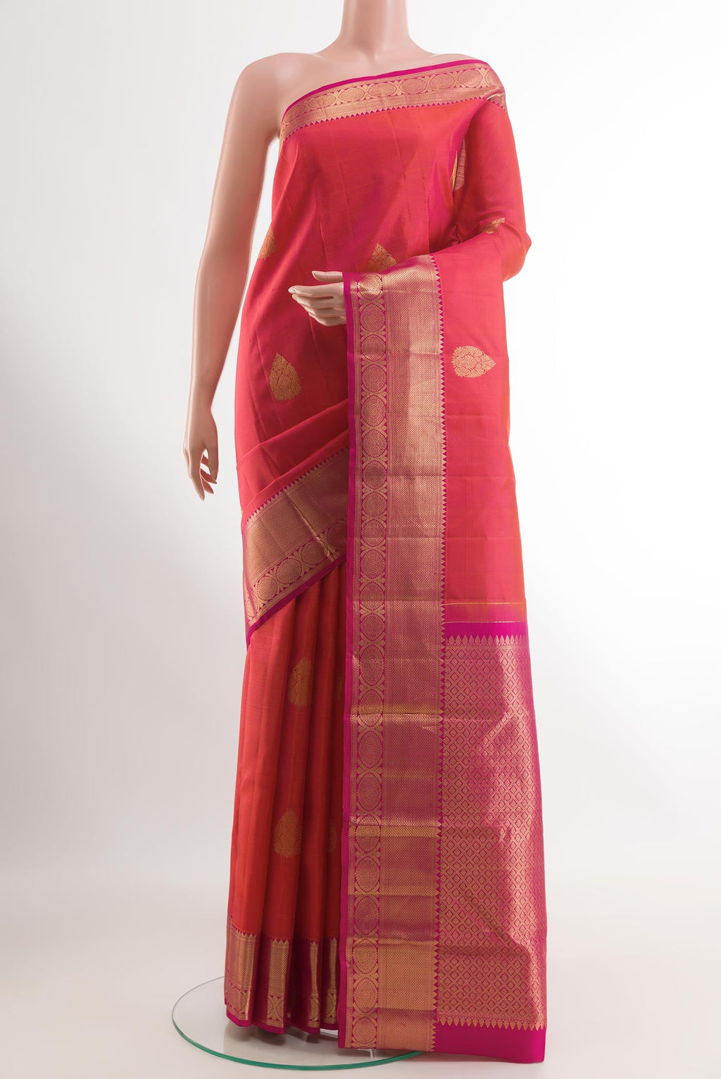 Pink Kanchipuram Silk Saree with Zari Butta on the body and Zari Border.  displayed on a mannequin