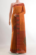 Brick Orange Kanjivaram Silk Saree with Zari Butta on the body and Thread Border.  displayed on a mannequin