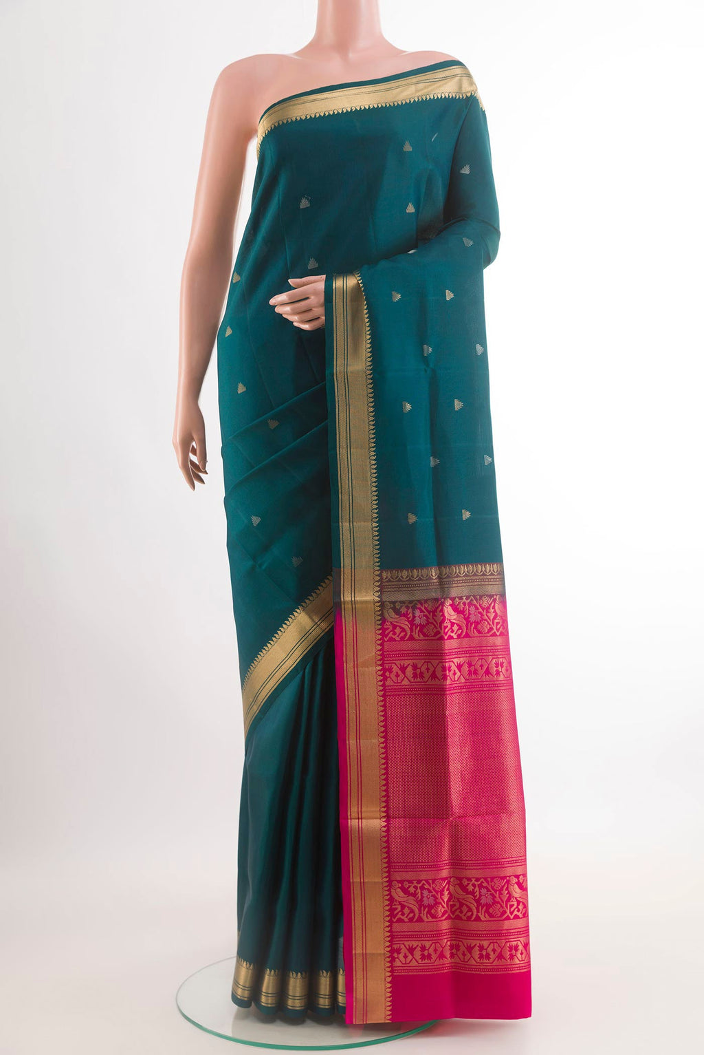Teal Soft Silk Saree with Zari Butta on the body and Zari Border.  displayed on a mannequin