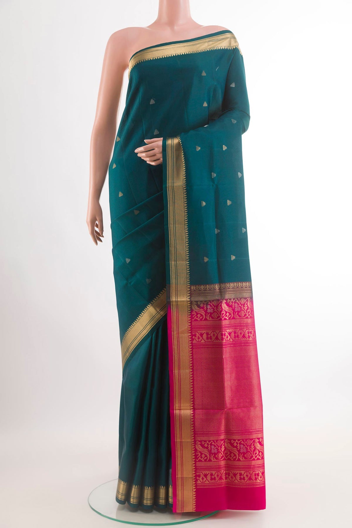 Teal Soft Silk Saree with Zari Butta on the body and Zari Border.  displayed on a mannequin