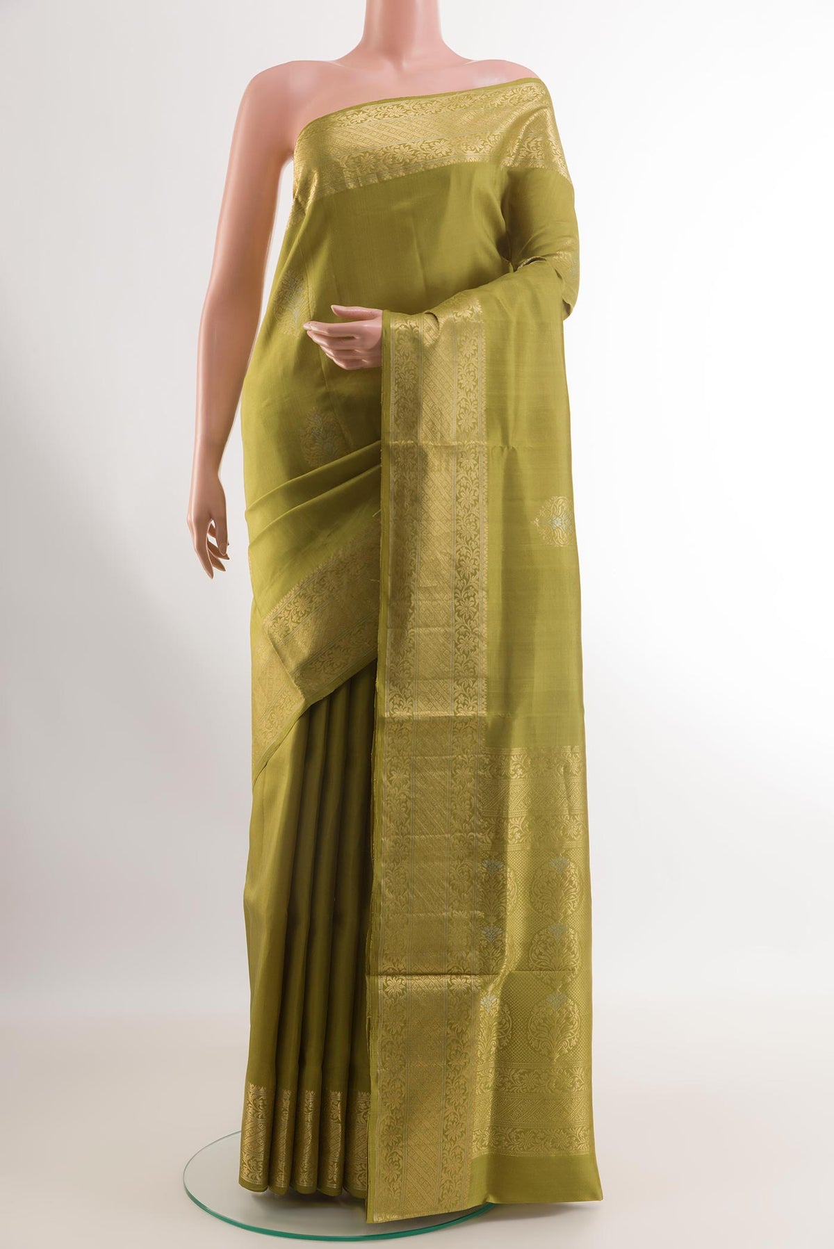 Mehandi Green Soft Silk Saree with Zari Butta on the body and Zari Border.  displayed on a mannequin