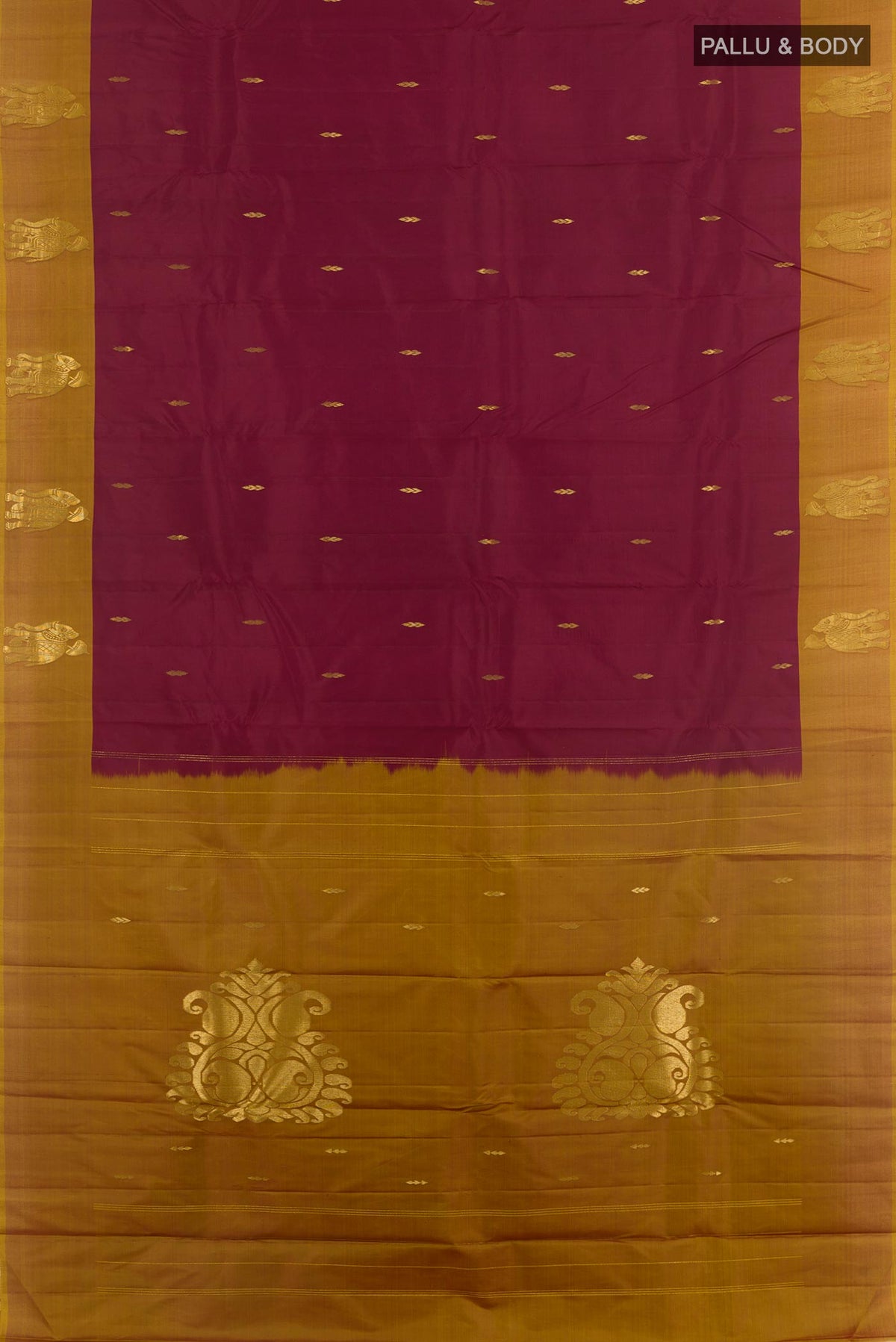 Flat view of Maroon Kanchipuram Silk Saree with Zari Butta on the body and Zari Border. 