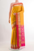 Yellow Soft Silk Saree with Jacquard design on the body and Zari Border.  displayed on a mannequin