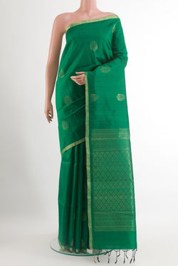 Green Raw Silk Saree with Zari Butta on the body and Zari Border.  displayed on a mannequin