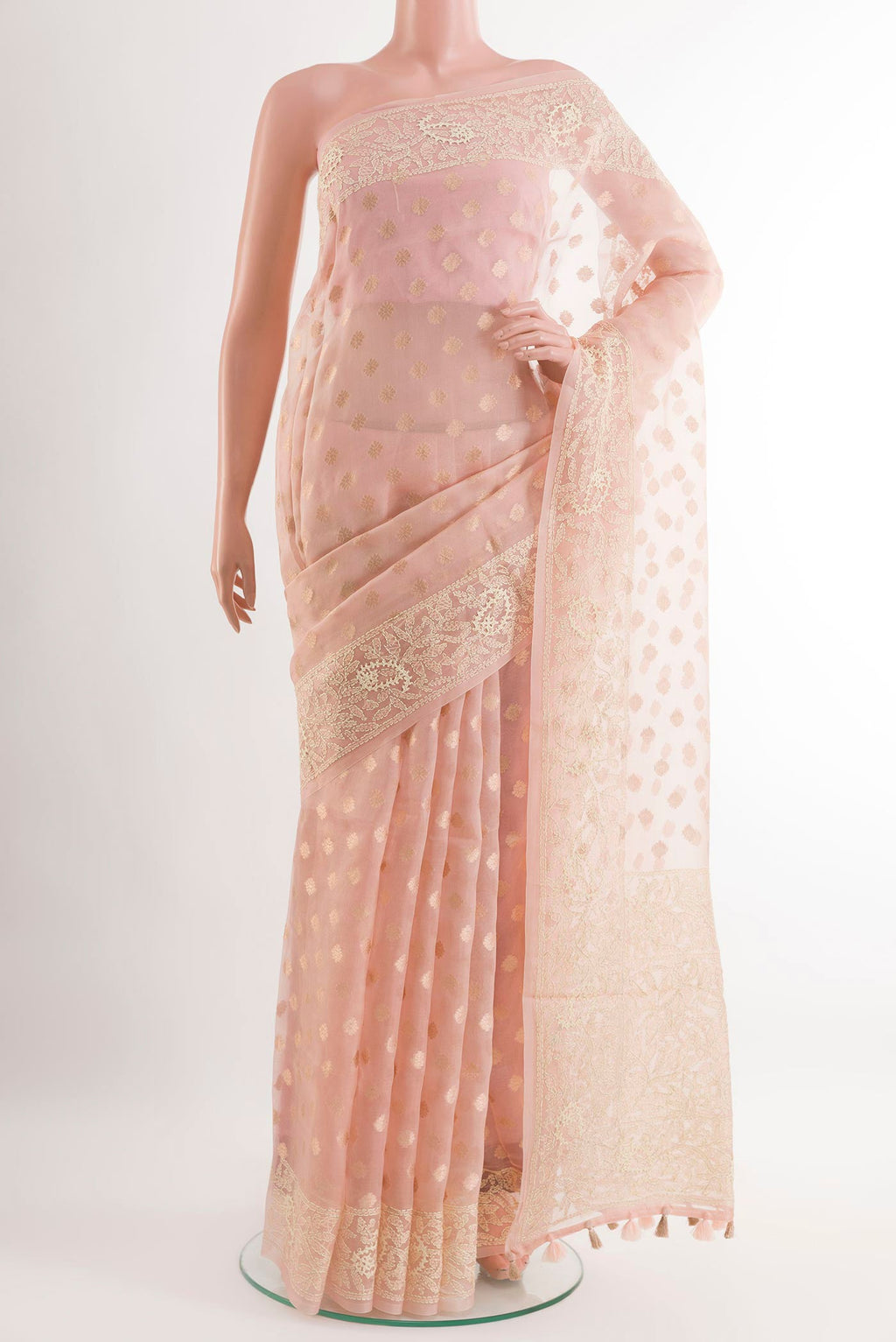 Peach Organza Silk Saree with Zari Butta on the body and Embroidery Border.  displayed on a mannequin