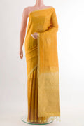 Yellow Soft Silk Saree with Zari Butta on the body and Zari Border.  displayed on a mannequin