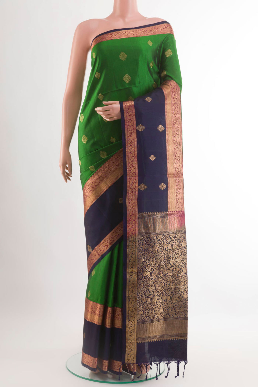 Green Soft Silk Saree with Zari Butta on the body and Zari Border.  displayed on a mannequin