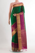 Green Soft Silk Saree with Ikat design on the body and Zari Border.  displayed on a mannequin