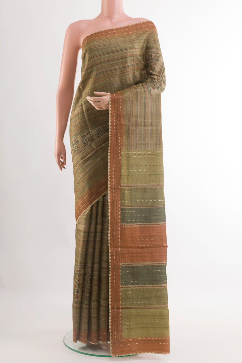 Green Tussar Saree with Printed design on the body and Zari Border.  displayed on a mannequin