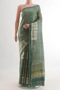 Green Tussar Silk Saree with Printed design on the body and Printed Border.  displayed on a mannequin