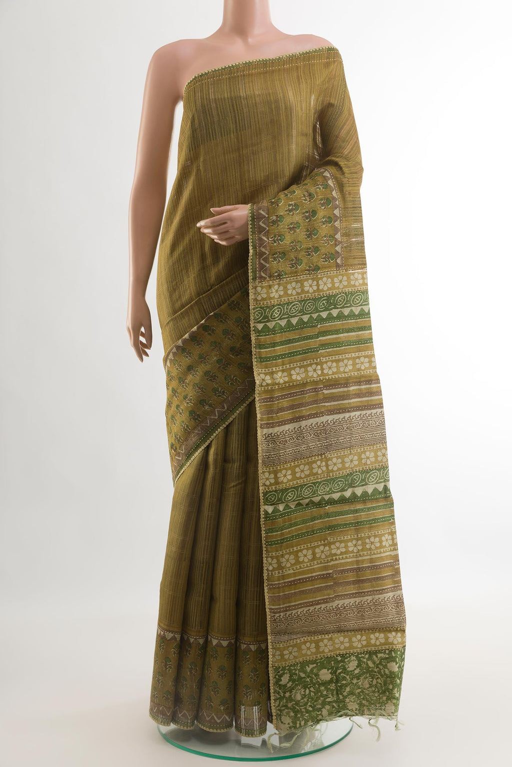 Mehandi Green Tussar Saree with Printed design on the body and Printed Border.  displayed on a mannequin