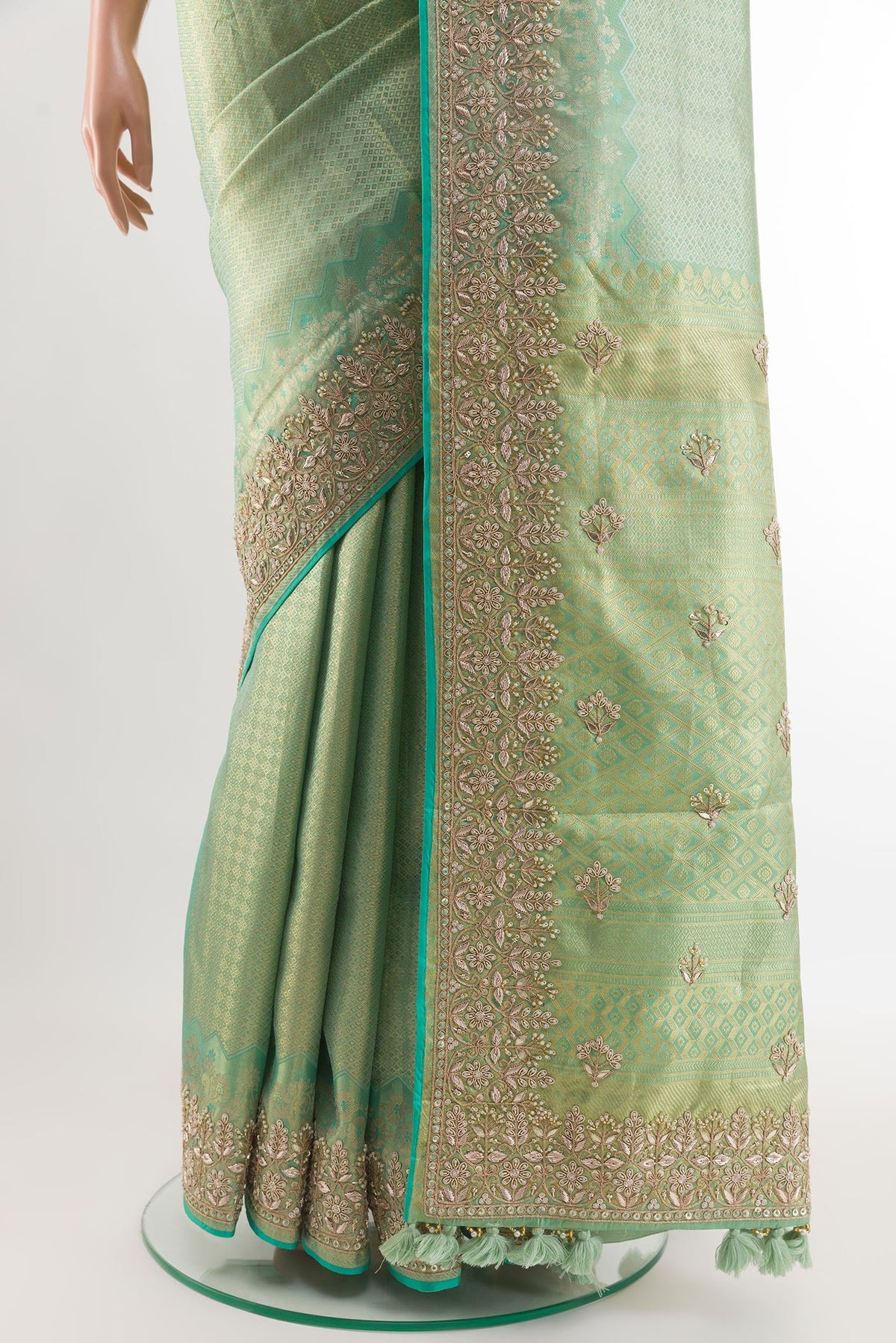 Pleats and pallu of Sea Green Kanjivaram Tissue Silk Saree with Zari Butta on the body and Embroidery Border. 