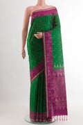 Green Soft Silk Saree with Zari Butta on the body and Zari Border.  displayed on a mannequin