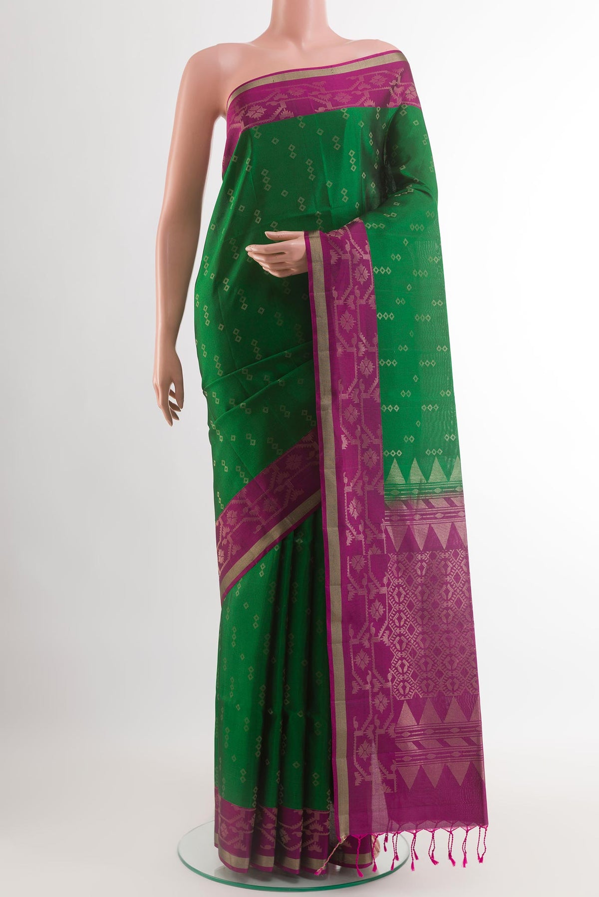 Green Soft Silk Saree with Zari Butta on the body and Zari Border.  displayed on a mannequin