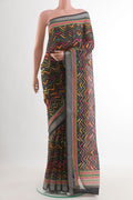 Black Tussar Silk Saree with Printed design on the body and Zari Border.  displayed on a mannequin