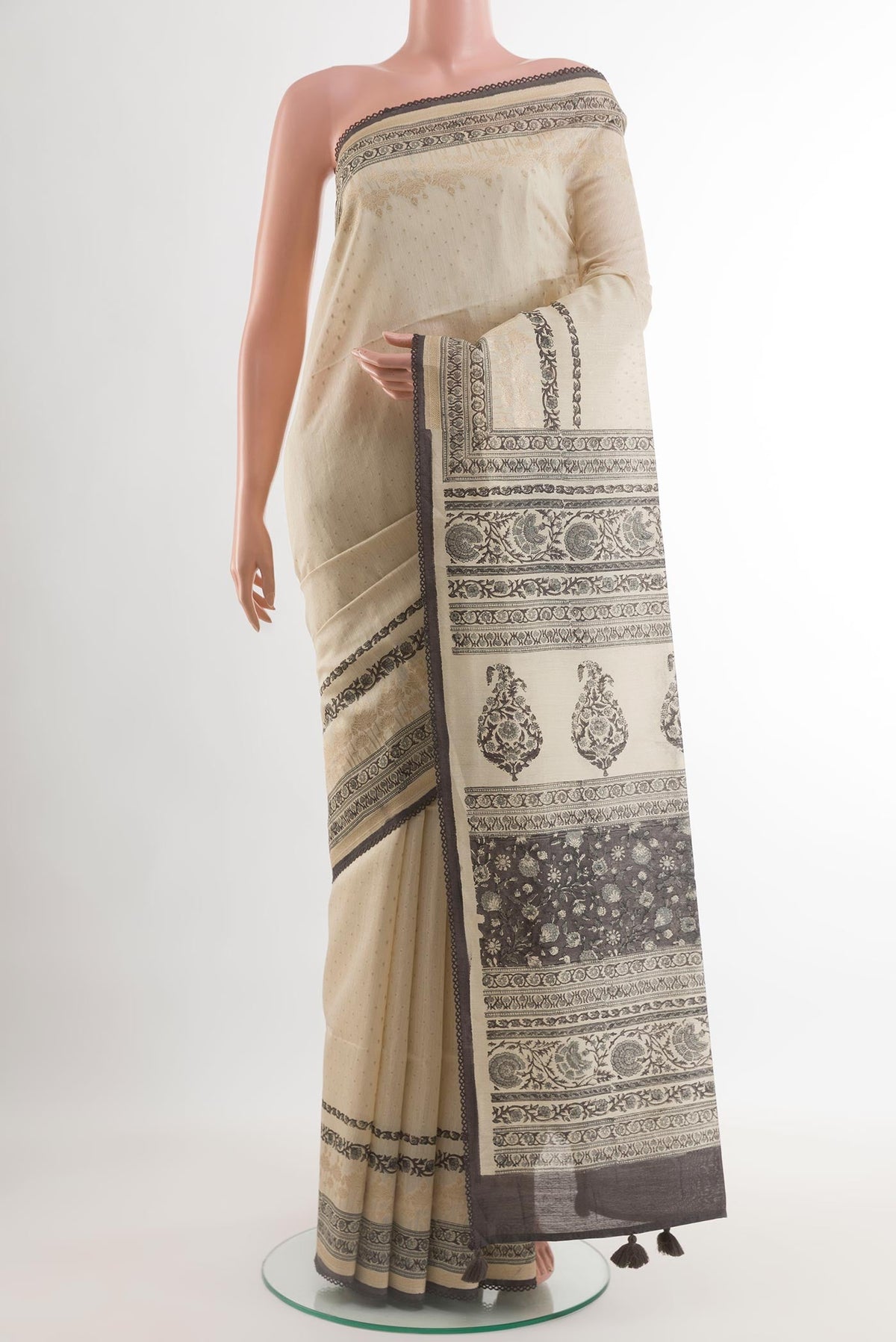 Cream Tussar Silk Saree with Printed design on the body and Printed Border.  displayed on a mannequin
