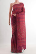 Maroon Tussar Silk Saree with Printed design on the body and Printed Border.  displayed on a mannequin