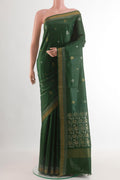 Bottle Green Tussar Silk Saree with Zari Butta on the body and Zari Border.  displayed on a mannequin