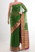 Green Blended Kora Cotton Saree with Zari Butta on the body and Zari Border.  displayed on a mannequin
