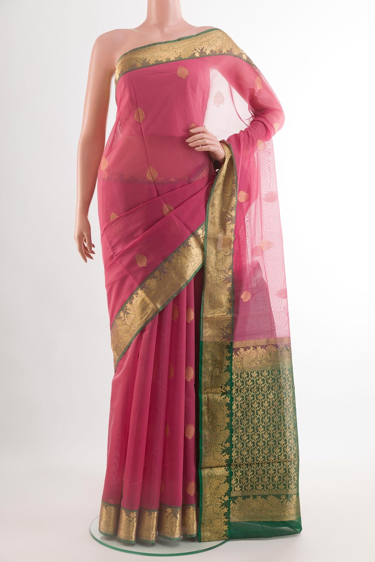 Pink Silk Cotton Saree with Zari Butta on the body and Zari Border.  displayed on a mannequin