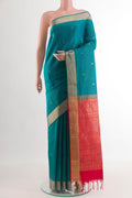 Peacock Blue Soft Silk Saree with Zari Butta on the body and Zari Border.  displayed on a mannequin