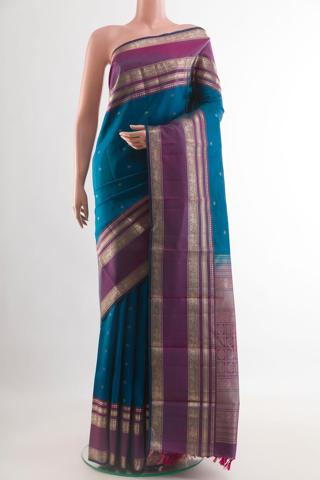 Blue Kanchipuram Silk Saree with Zari Butta on the body and Zari Border.  displayed on a mannequin