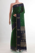 Green Kanjivaram Silk Saree with Zari Butta on the body and Zari Border.  displayed on a mannequin