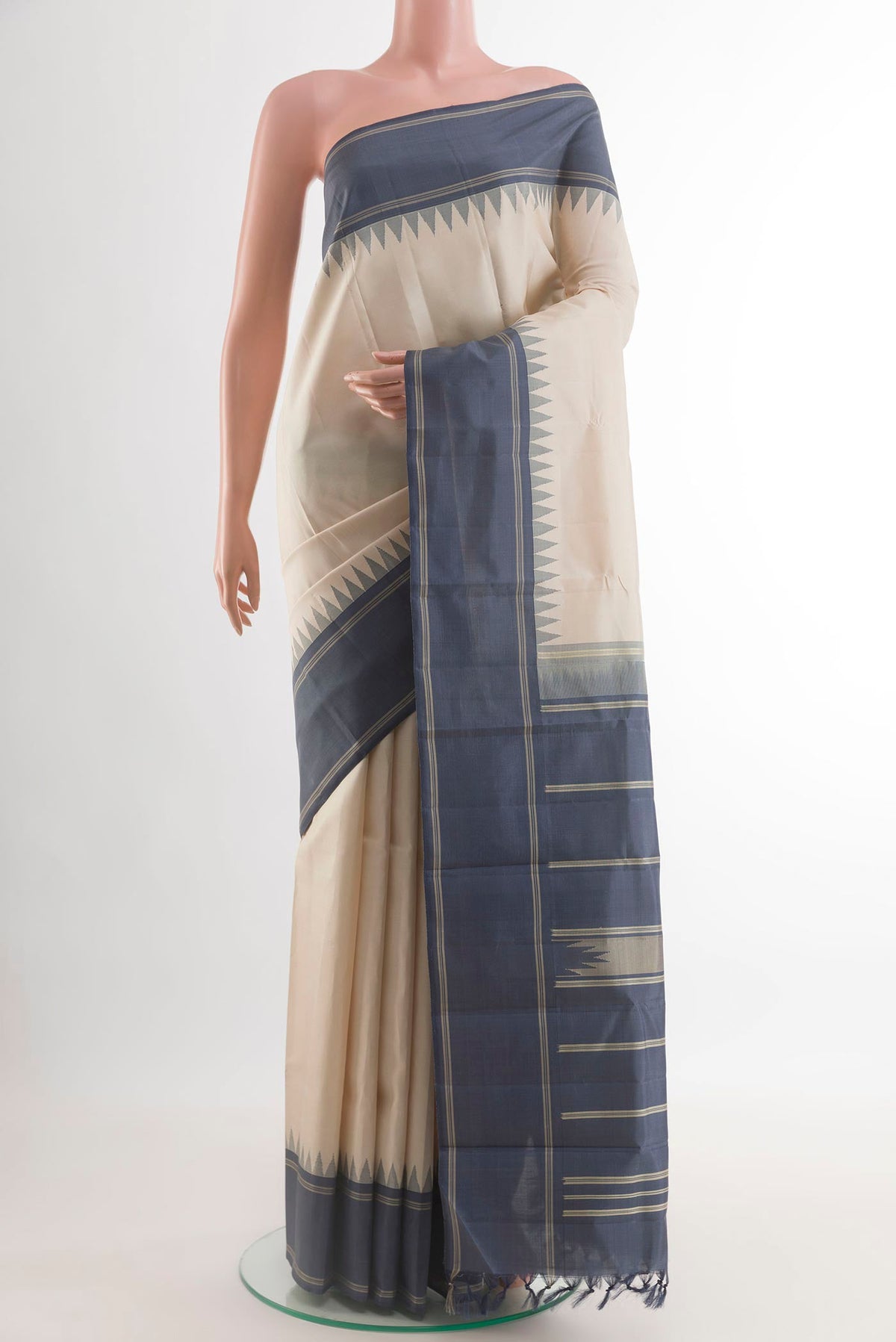 Off White Kanchipuram Silk Saree with Plain Body and Temple Thread Border.  displayed on a mannequin