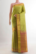 Light Green Kanjivaram Silk Saree with Zari Butta on the body and Zari Border.  displayed on a mannequin