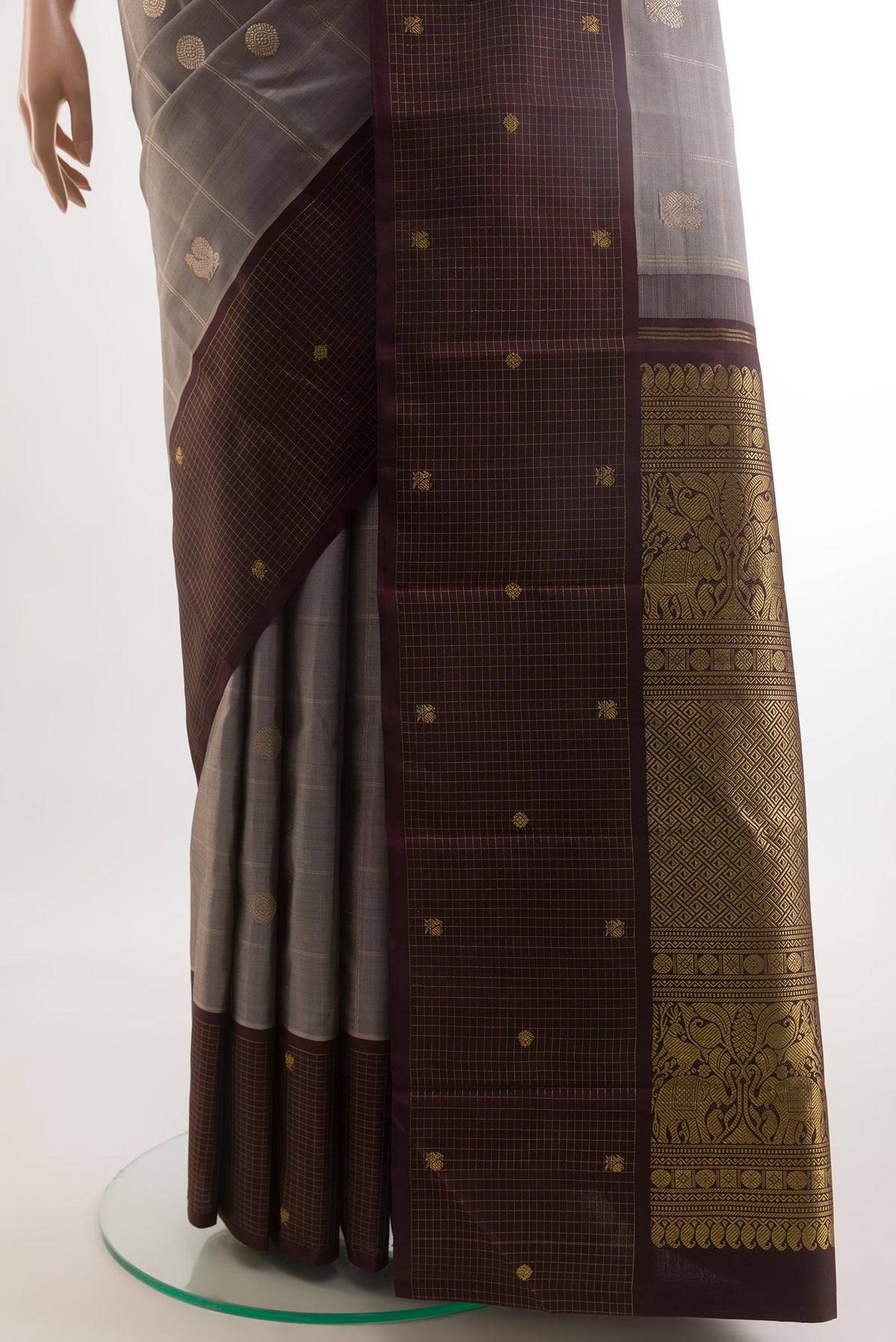 Pleats and pallu of Grey Kanjivaram Silk Saree with Checked design on the body and Checks Border. 