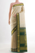 Off White Kanchipuram Silk Saree with Zari Butta on the body and Zari Border.  displayed on a mannequin