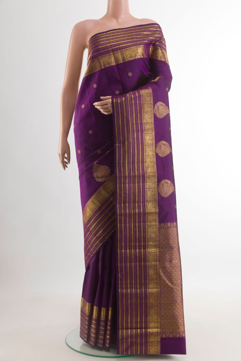 Purple Kanjivaram Silk Saree with Zari Butta on the body and Zari Border.  displayed on a mannequin