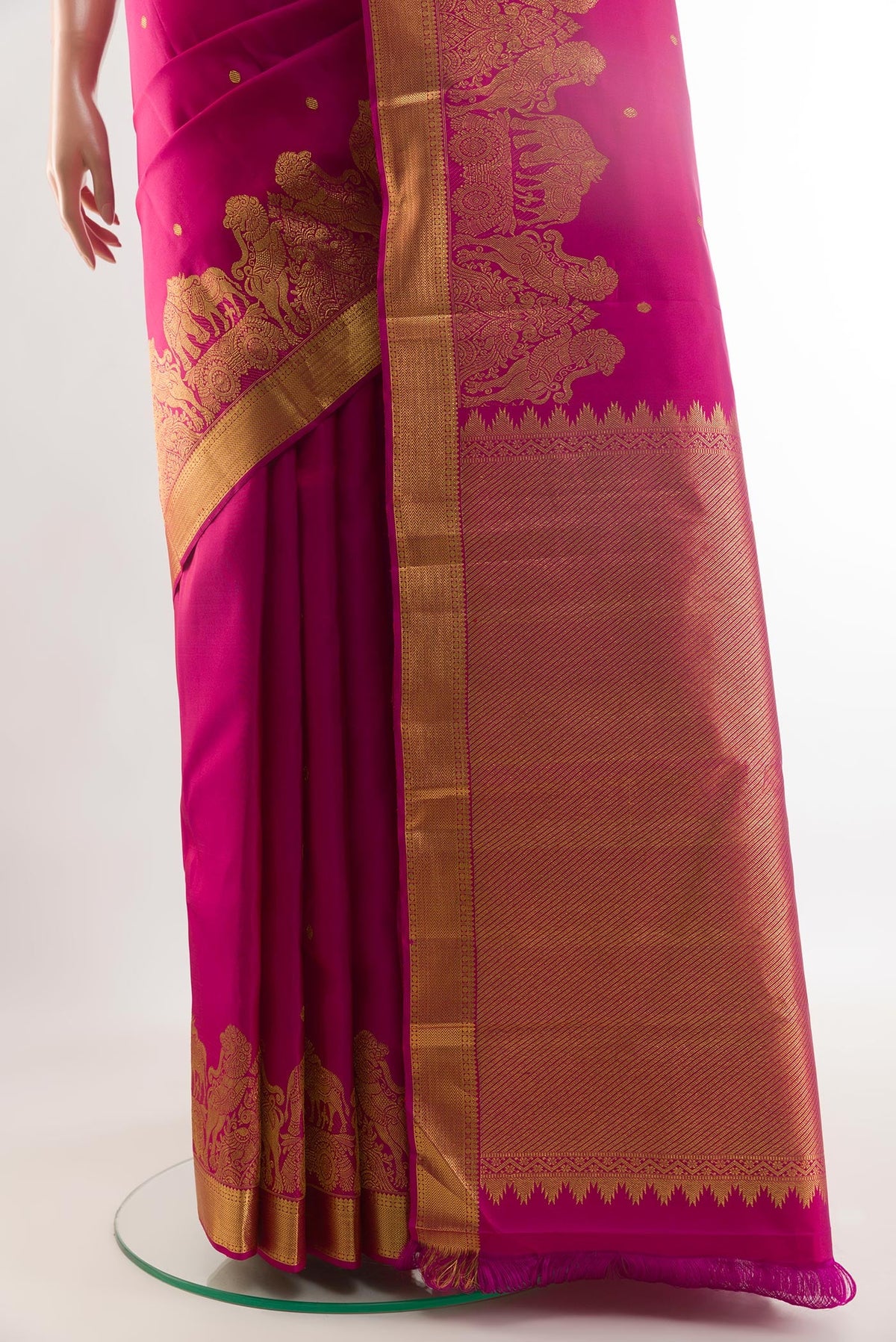 Pleats and pallu of Rani Pink Kanjivaram Silk Saree with Zari Butta on the body and Zari Border. 