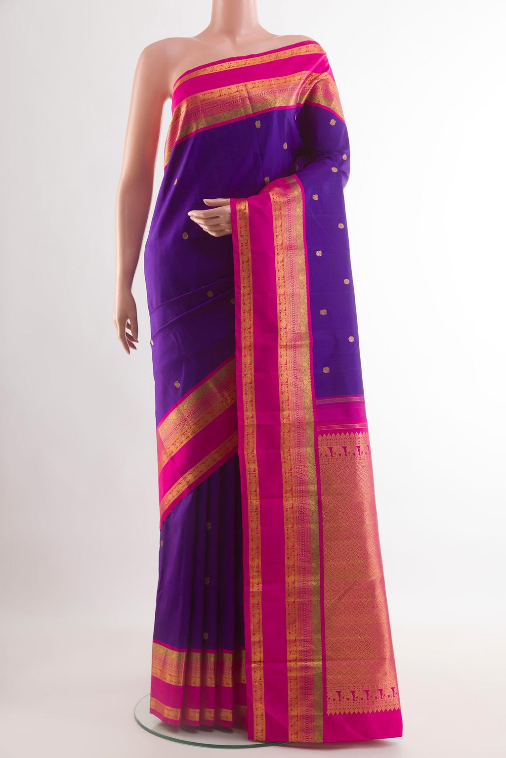 Blue Kanchipuram Silk Saree with Zari Butta on the body and Zari Border.  displayed on a mannequin