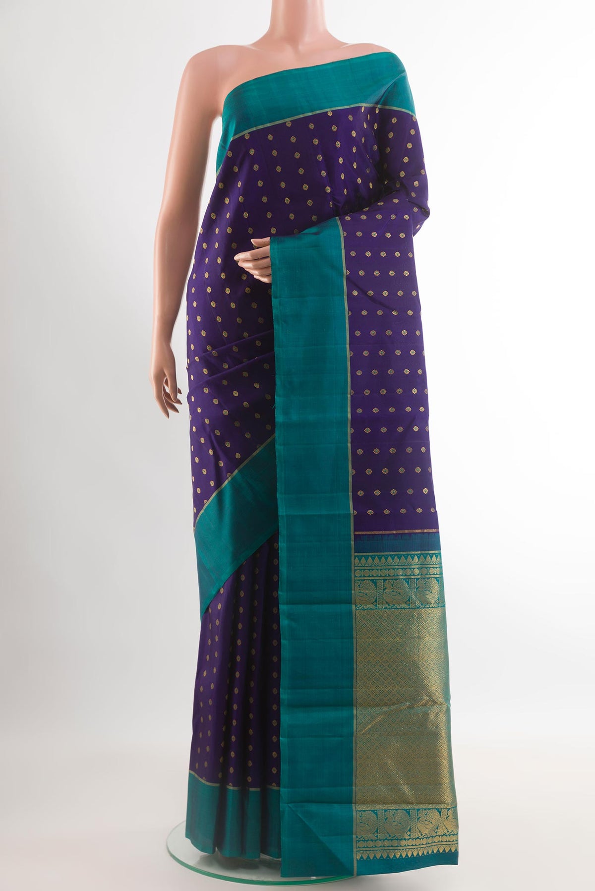 Navy Blue Kanchipuram Silk Saree with Zari Butta on the body and Zari Border.  displayed on a mannequin