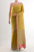 Yellow Tussar Silk Saree with Embroidery on the body and Zari Border.  displayed on a mannequin