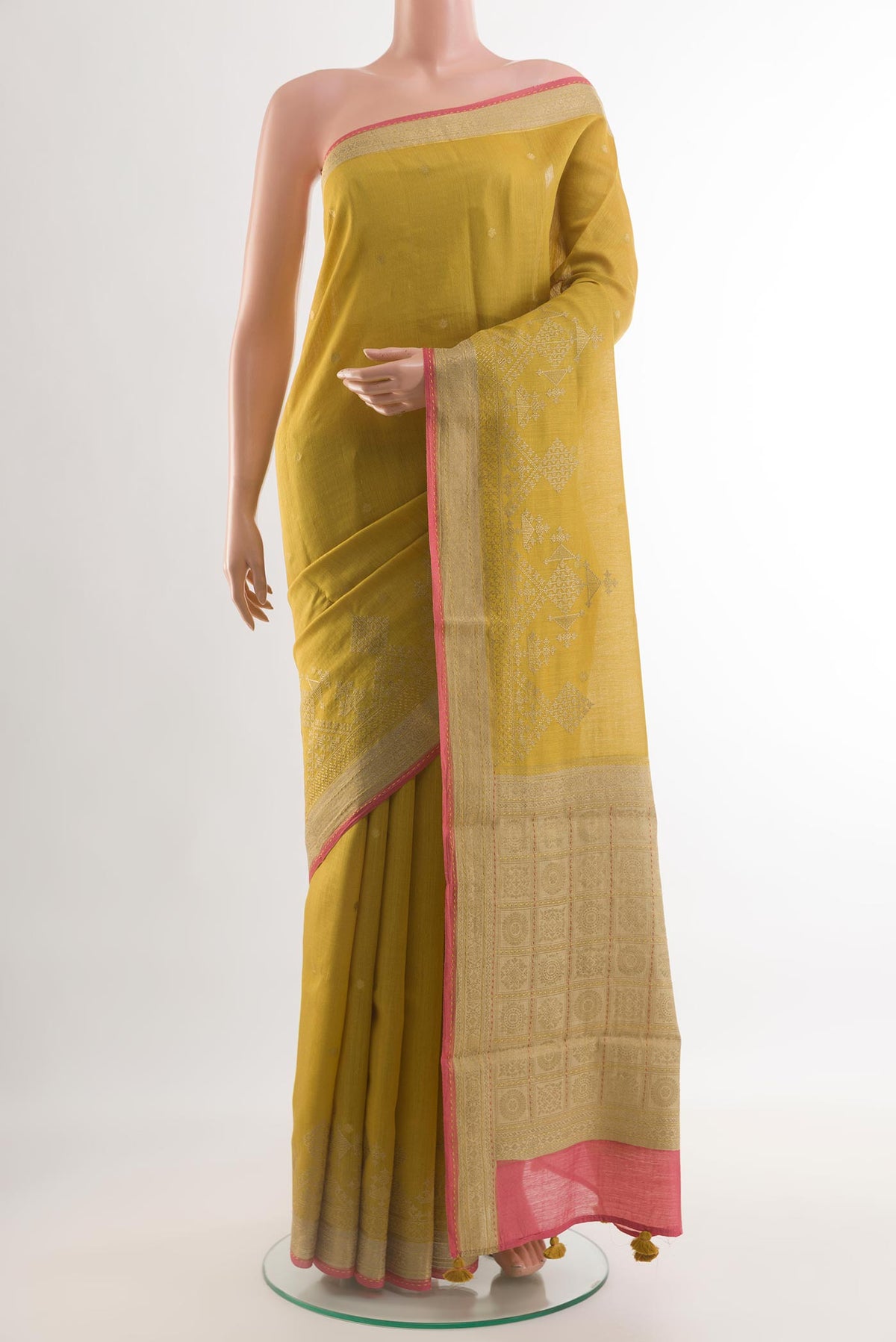 Yellow Tussar Silk Saree with Embroidery on the body and Zari Border.  displayed on a mannequin