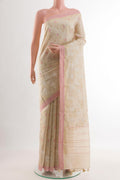 Beige Tussar Saree with Embroidery on the body and Zari Border.  displayed on a mannequin