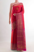 Brick Orange Dual Tone Kanchipuram Silk Saree with Zari Butta on the body and Zari Border.  displayed on a mannequin