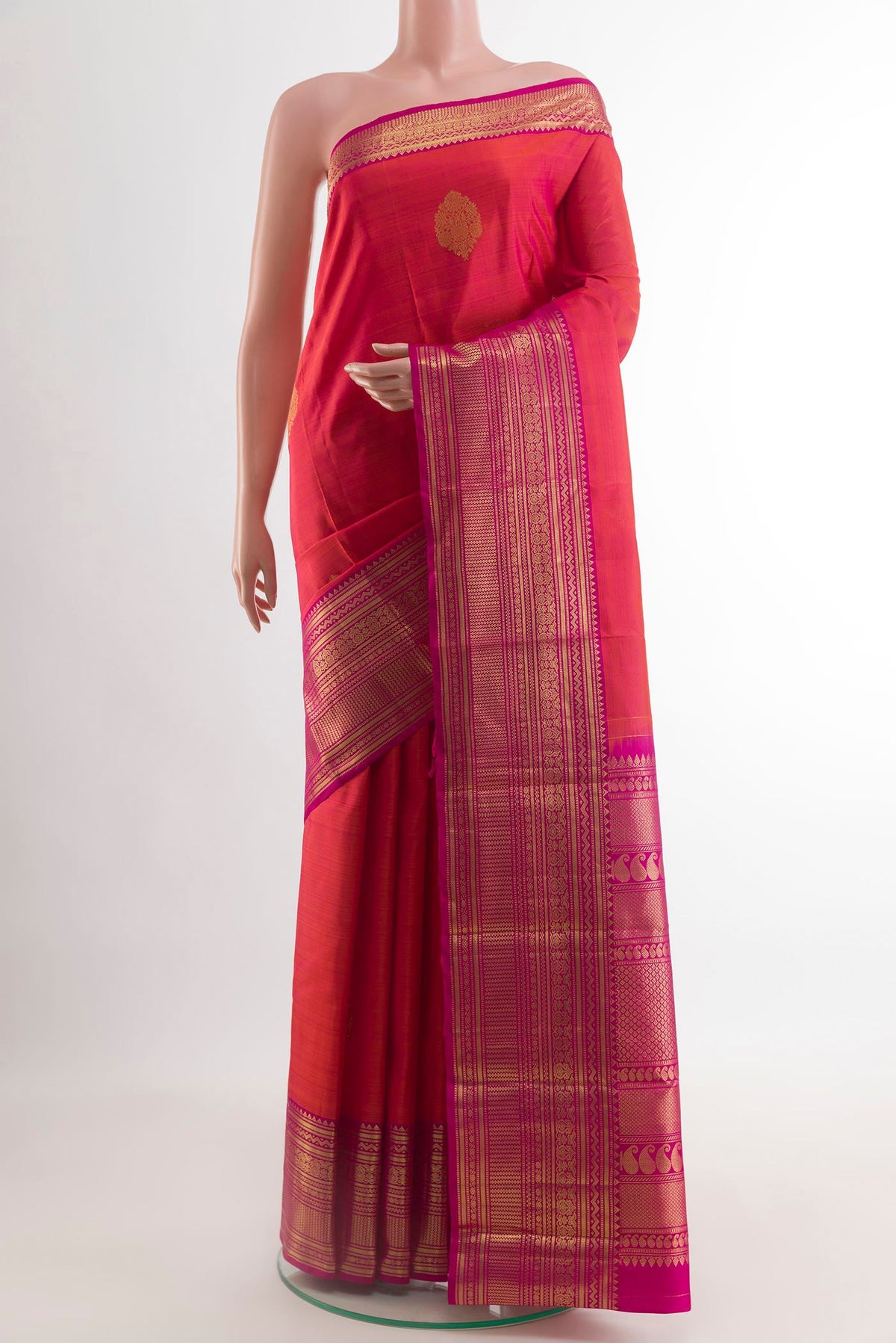 Brick Orange Dual Tone Kanchipuram Silk Saree with Zari Butta on the body and Zari Border.  displayed on a mannequin