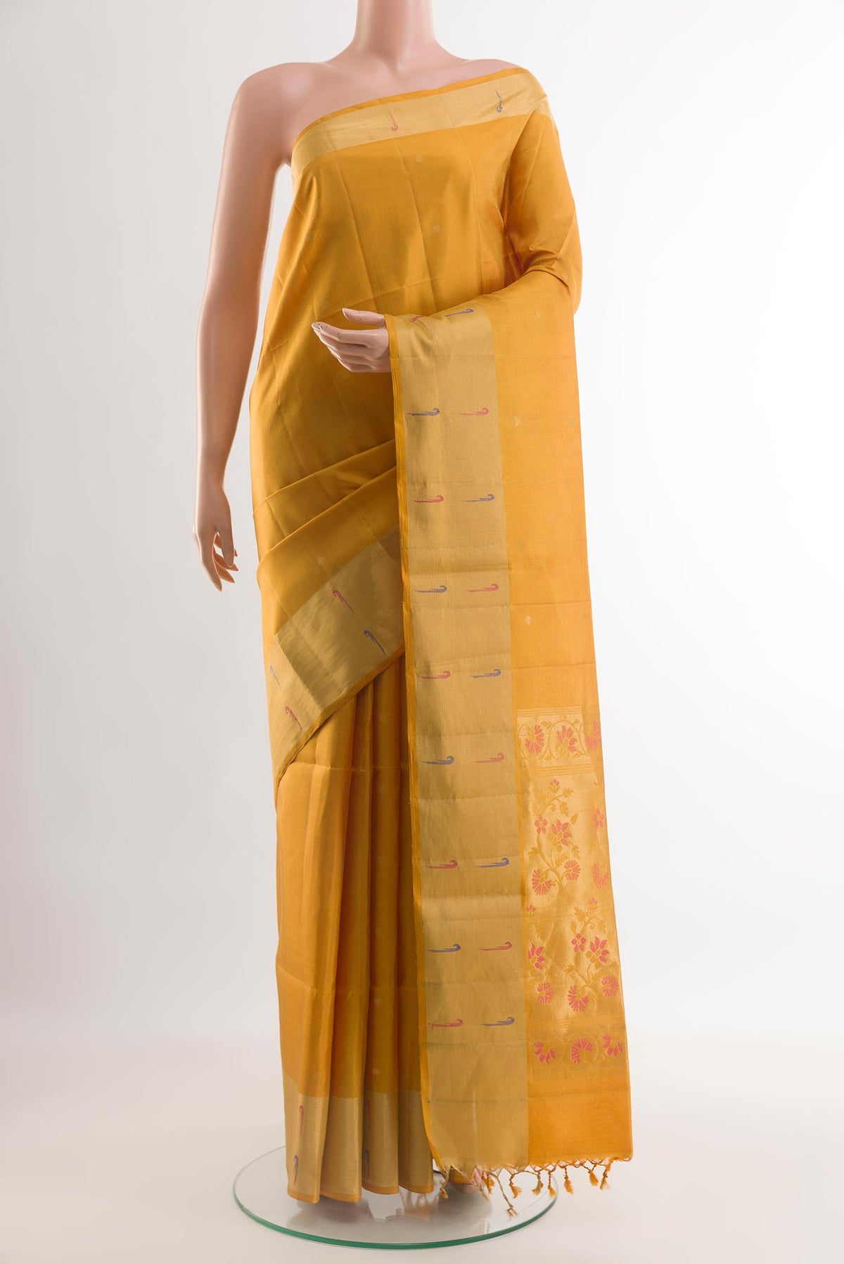 Yellow Soft Silk Saree with Zari Butta on the body and Zari Border.  displayed on a mannequin