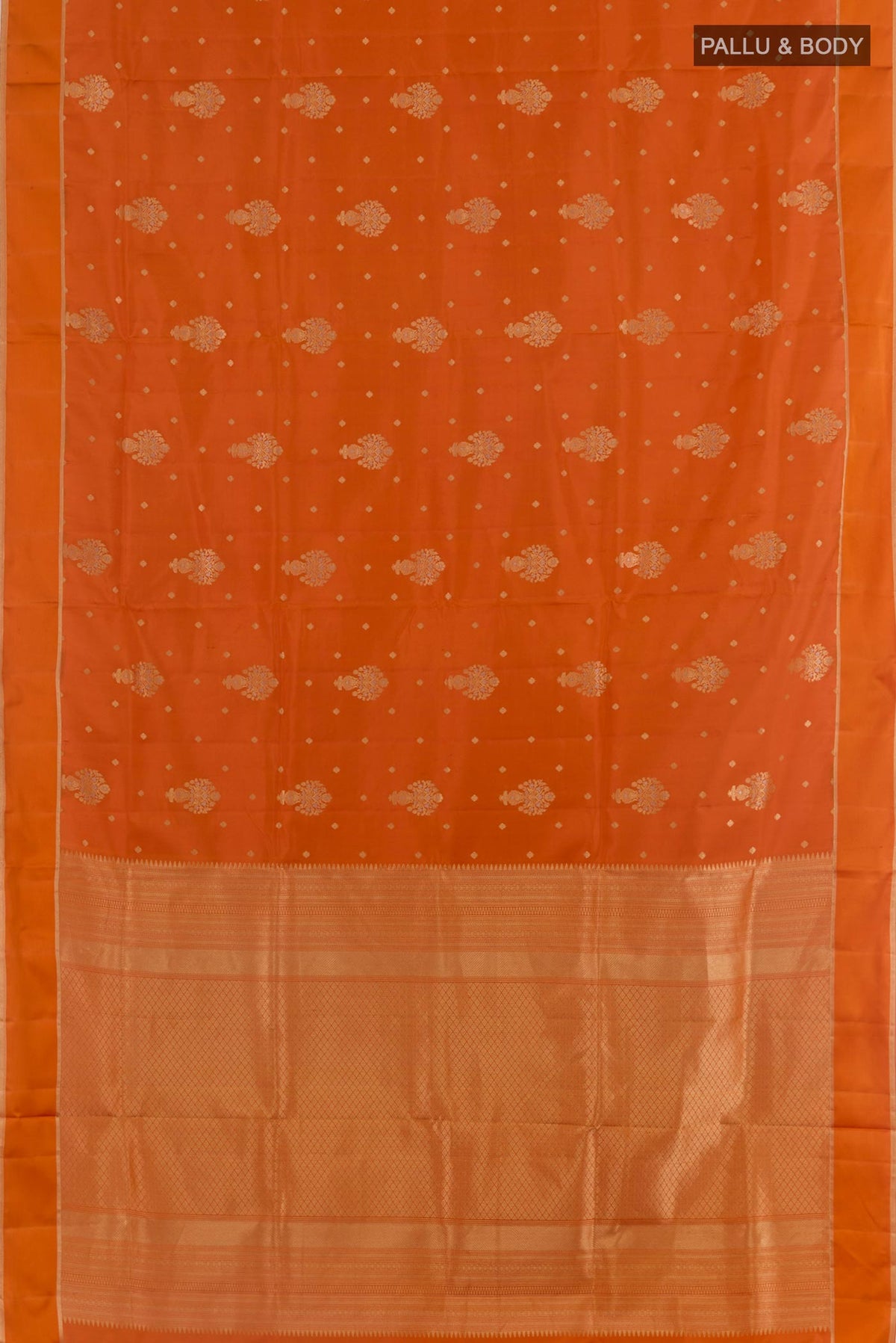 Flat view of Orange Soft Silk Saree with Zari Butta on the body and Zari Border. 