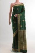 Bottle Green Soft Silk Saree with Zari Butta on the body and Zari Border.  displayed on a mannequin