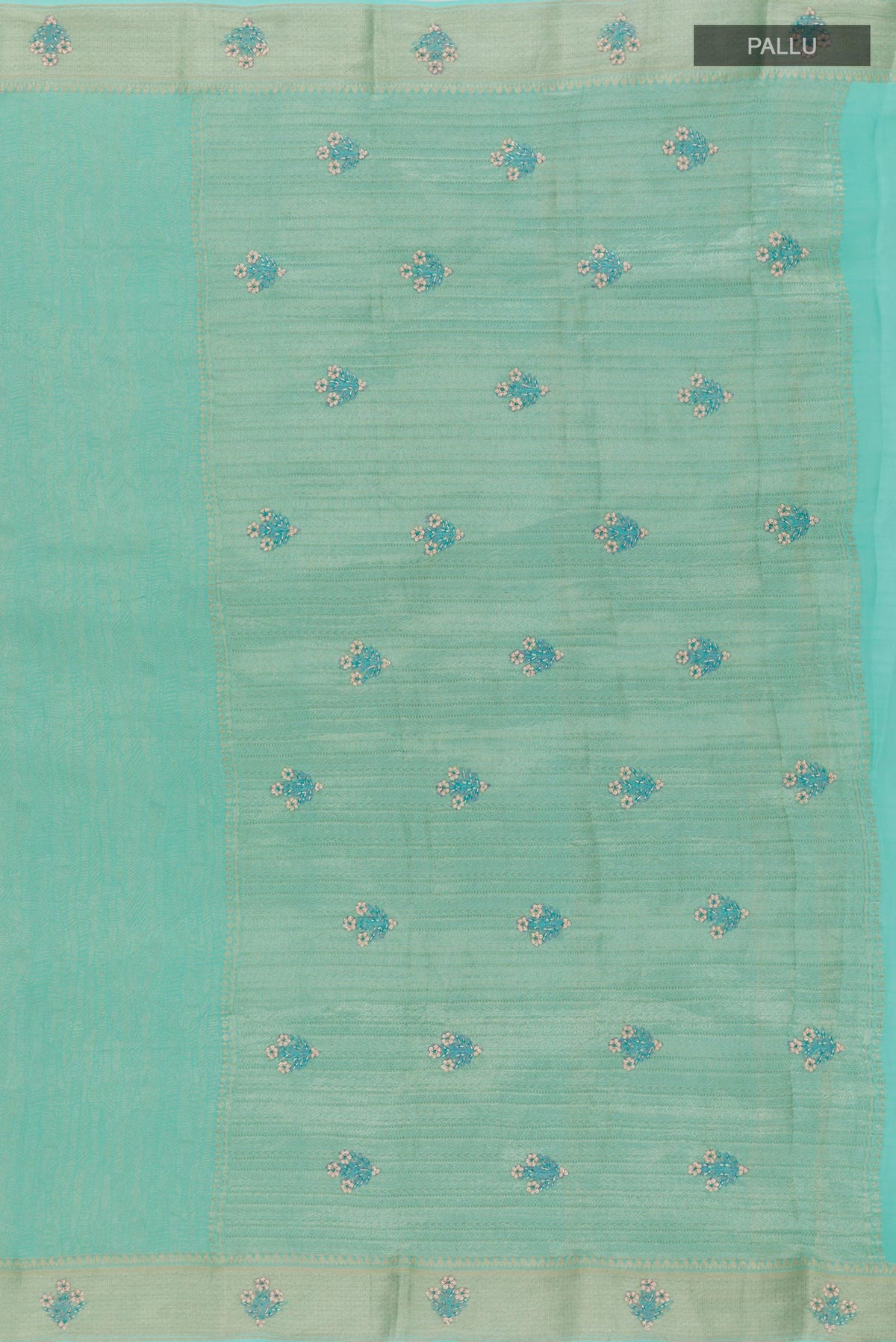 Close up image of the pallu of Turquoise Mysore Crepe Saree with Zari Brocade on the body and Zari Border. 
