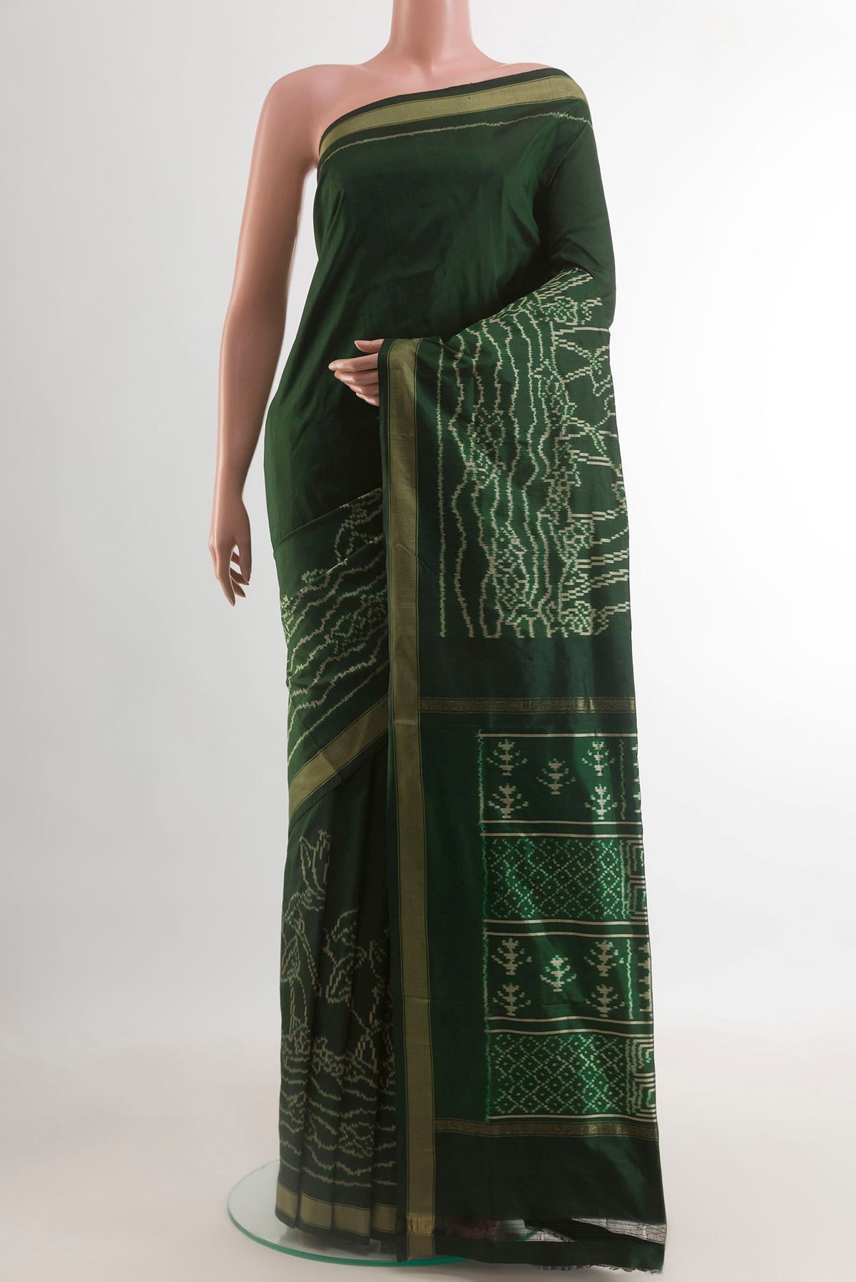 Bottle Green Pochampally Silk Saree with Ikat design on the body and Ikat Border.  displayed on a mannequin