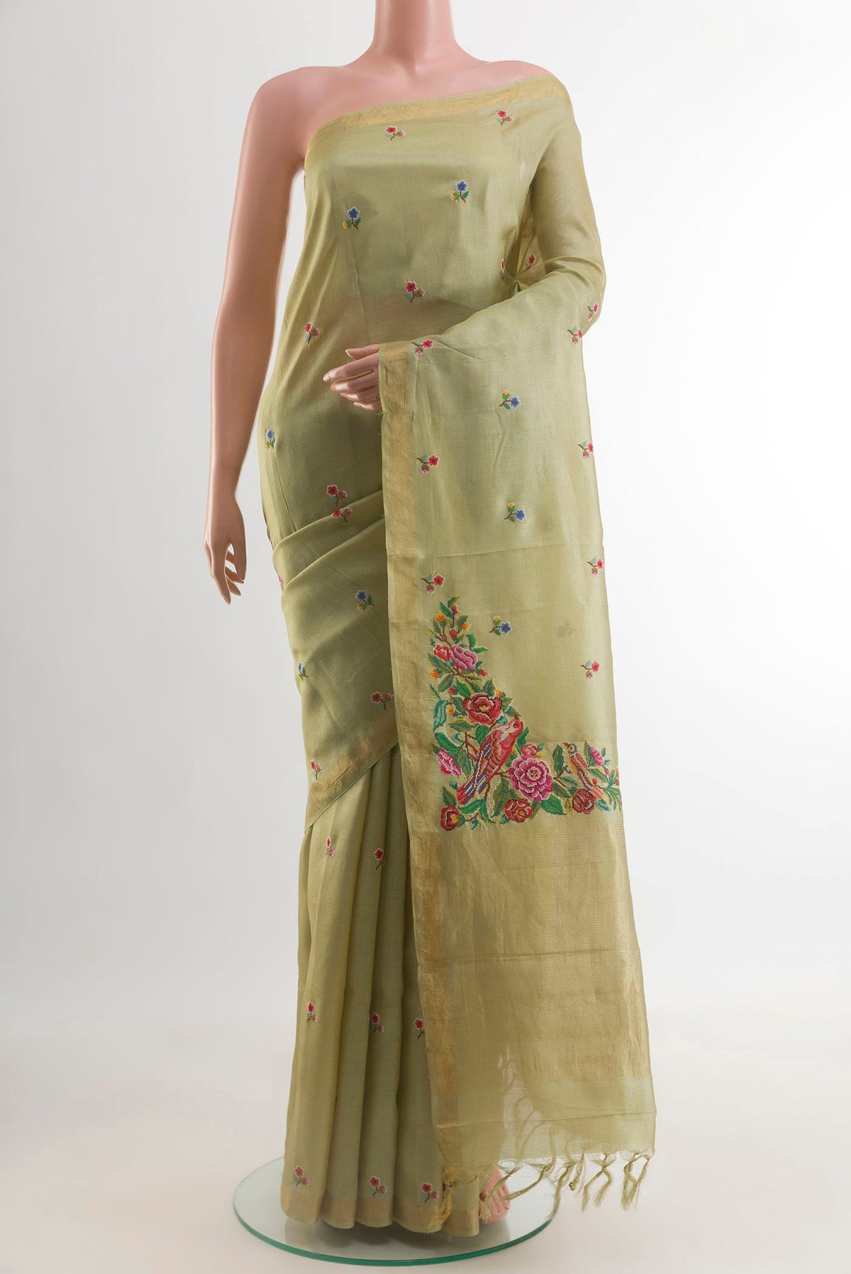 Beige Tussar Silk Saree with Embroidery on the body and Zari Border.  displayed on a mannequin