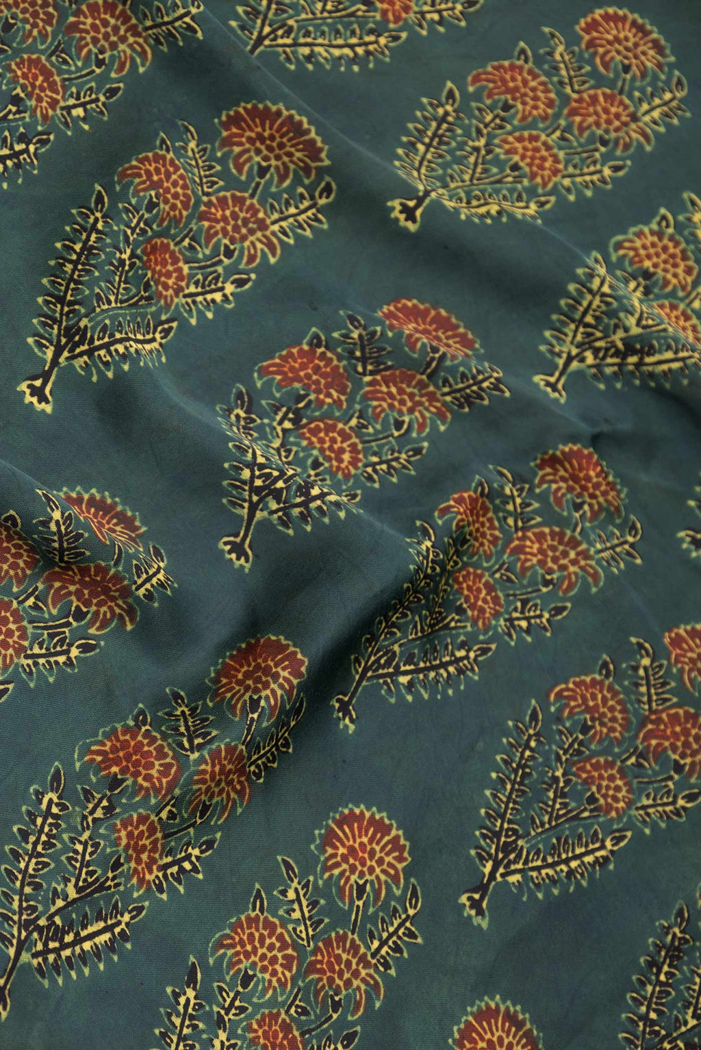 Close up of Green Dual Tone Linen Saree with Printed design on the body and Zari Border displaying folds