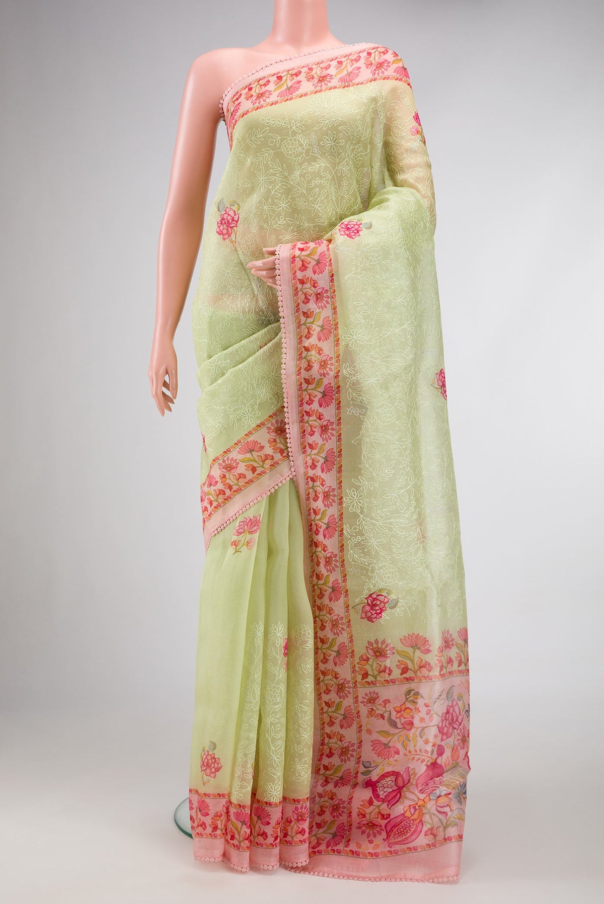 Pista Green Dual Tone Organza Silk Saree with Embroidery on the body and Printed Border.  displayed on a mannequin